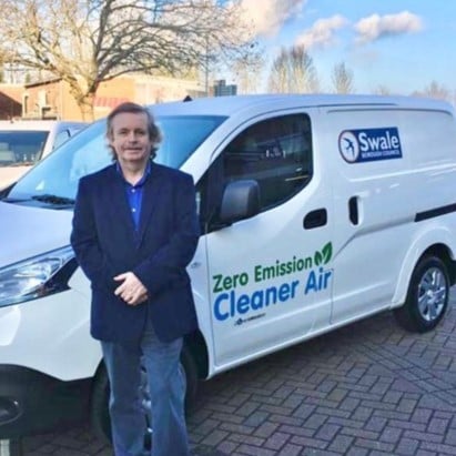 Photo of Tim Valentine in front of electric van