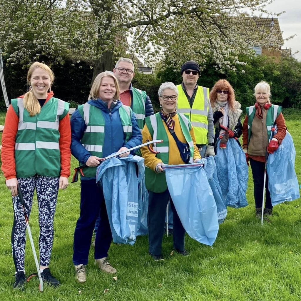 Photo of a group of people in a field collecting litter